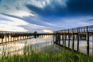 Fototapeta premium Wooden bridge cross around marsh in sunset time at Sam Roi Yot National Park,Thailand
