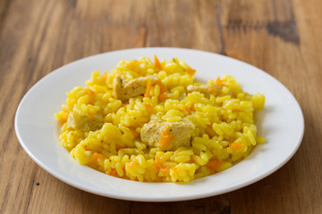 rice with meat and carrot on white plate
