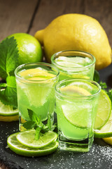 Green cocktail with vermouth, mint and citrus, selective focus