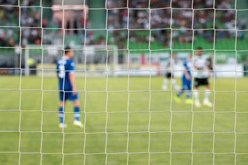 Football net during a football mach. Focus on the net