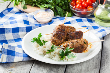 Barbecued kofta with rice on a plate