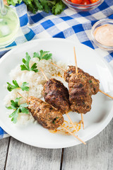 Barbecued kofta with rice on a plate