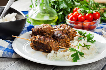 Barbecued kofta with rice on a plate