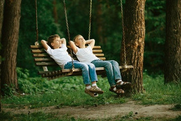 little boys dreaming on swing