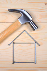 Hammer and nails on wooden background