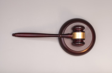 wooden judge gavel and soundboard on  grey background