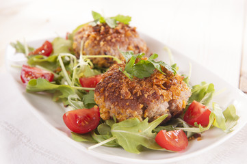 tasty chops with arugula and tomato 