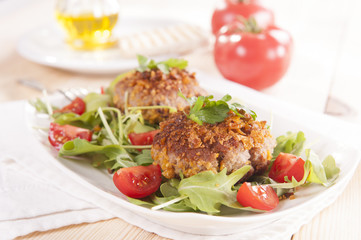 tasty chops with arugula and tomato 