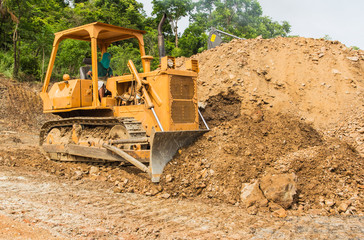 industrial  bulldozer moving earth and sand in sand pit or quarry