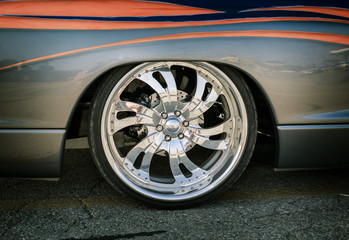 Fragment of amazing gorgeous closeup view of old classic vintage car body and alloy shiny fashionable stylish wheel