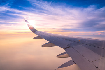Fototapeta na wymiar Looking through window aircraft wing during flight and look cloud in beautiful