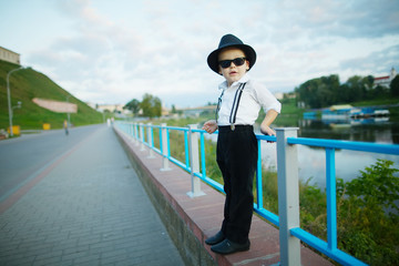 little gentleman with sunglasses outdoors