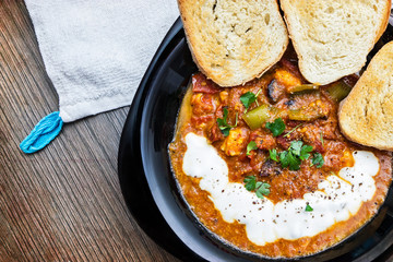 Stewed tomatoes and peppers, served with toast and cream