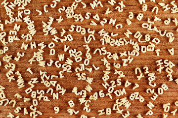 Alphabet pasta on wood background