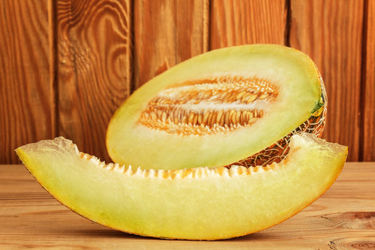 Sliced melon on wooden background close-up