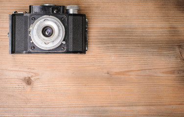 retro camera on wooden background