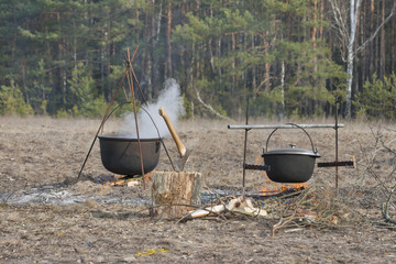 cooking in large cauldrons on the fire