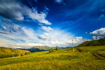 clouds and green meadows in hills  mountains of  Altai