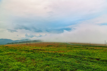 multicolored fog on the mountain pass of Altai