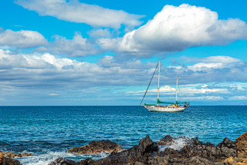 A sailboat moored off the coast of Kamaole Beach in Kihei on Maui, Hawaii