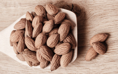 Almonds on wooden spoon