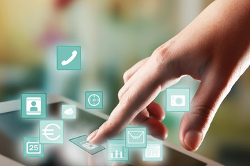 Finger touching tablet PC screen and icons around