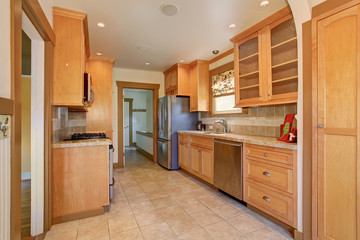 Traditional kitchen with stainless steel fridge.