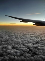 Flying above the clouds at sunset