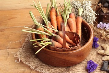 Fresh carrots on the wood background