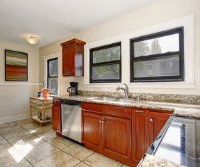 Well defined kitchen with large tile floor.