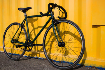 Fototapeta na wymiar Green sport bike on a yellow background