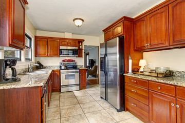 Well defined kitchen with large tile floor.