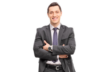 Confident young businessman in a gray suit looking at the camera