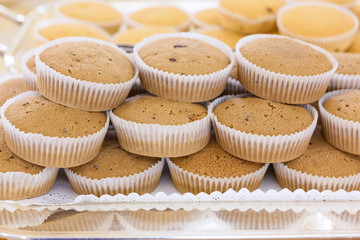 Brown cupcakes on silver tray in a hotel restaurant served for b