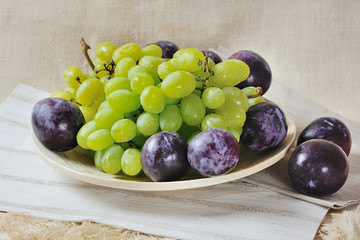 grapes and plums on plate
