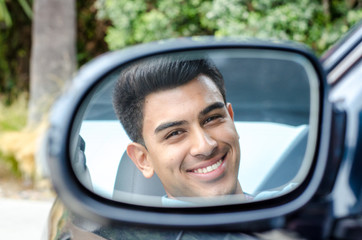 Teen sitting in car, looking serious