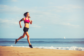 Sports Fitness Woman Running on the Beach at Sunset