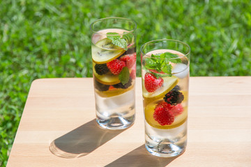 Infused water with berries and golden kiwi. Refreshing drink.