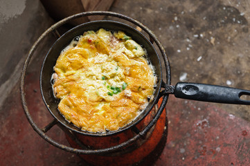 Fry egg on picnic stove to lunch.