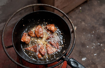 Frying dried meat on picnic stove.