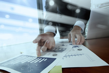 Double exposure of business man hand working on blank screen lap