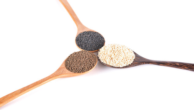 Organic sesame seeds with wooden scoop over white background