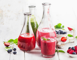 Healthy fresh smoothies on  white wooden table.