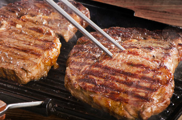 Beef steaks on a grill pan.