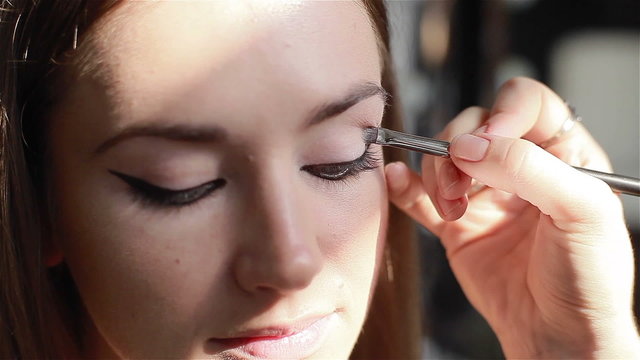 Professional eye make-up: eyeshadow application. Close-up