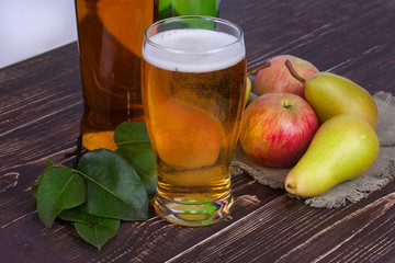 Apple and pear cider glass and bottles with fruits