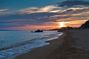 Waves on a sandy beach at sunset, west coast of Sithonia