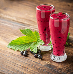 Two glass glasses with black currant smoothie