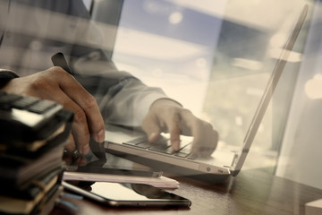 designer hand working with digital tablet and laptop and noteboo