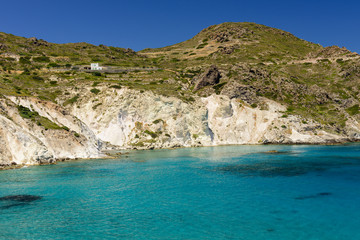 Beautiful coast - azure water and high mountains, Mandrakia village, Milos island, Greece.